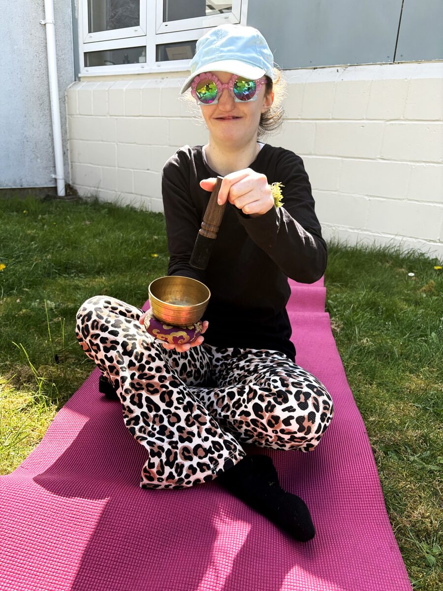 Sound healing session - student with singing bowl outdoors